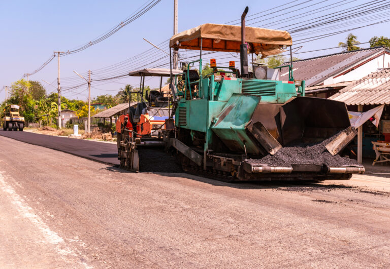 Close view on the workers and the asphalting machines, Workers making asphalt at road construction